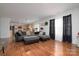 Open-concept living room with kitchen view and sleek wood flooring at 8511 Redding Glen Ave, Charlotte, NC 28216