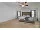 Spacious main bedroom featuring neutral walls, plush carpet, and a ceiling fan at 8511 Redding Glen Ave, Charlotte, NC 28216