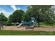 Community playground featuring slides and climbing structures, surrounded by lush greenery at 8511 Redding Glen Ave, Charlotte, NC 28216