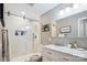Updated bathroom featuring a tiled walk-in shower, vanity with marble countertop, and modern fixtures at 8612 Tintinhull Ln, Waxhaw, NC 28173