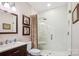 Modern bathroom features a glass-enclosed shower, stylish vanity, and elegant tile work at 8612 Tintinhull Ln, Waxhaw, NC 28173