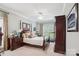 Well-lit bedroom features a traditional bed frame with an upholstered headboard and matching furniture at 8612 Tintinhull Ln, Waxhaw, NC 28173