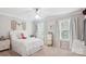 Bright bedroom featuring a white ceiling fan, neutral walls, two windows and decorative artwork at 8612 Tintinhull Ln, Waxhaw, NC 28173
