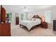Spacious bedroom with a large bed, bedside tables, and plenty of natural light from the windows at 8612 Tintinhull Ln, Waxhaw, NC 28173