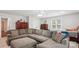 A cozy bedroom featuring a large sectional sofa, comfortable bed, and classic wooden furniture with natural light at 8612 Tintinhull Ln, Waxhaw, NC 28173