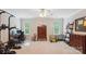 Bright bonus room with a ceiling fan is furnished with exercise equipment, desk, and cabinet at 8612 Tintinhull Ln, Waxhaw, NC 28173