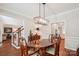 Traditional dining room featuring hardwood floors, an elegant chandelier, and classic furnishings at 8612 Tintinhull Ln, Waxhaw, NC 28173