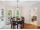 Cozy dining area featuring a round wood table, natural light, and access to an outdoor screened-in porch at 8612 Tintinhull Ln, Waxhaw, NC 28173