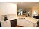 Open kitchen featuring white countertops and cabinetry, modern appliances, and direct view of the living room at 8612 Tintinhull Ln, Waxhaw, NC 28173