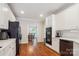 Bright kitchen featuring white cabinets, stainless steel appliances, and hardwood floors at 8612 Tintinhull Ln, Waxhaw, NC 28173
