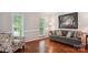 Cozy living room with hardwood floors, large windows, and comfortable seating at 8612 Tintinhull Ln, Waxhaw, NC 28173