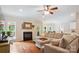 Open concept living room with a fireplace, hardwood floors, and a comfortable sectional sofa at 8612 Tintinhull Ln, Waxhaw, NC 28173