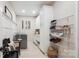 Well-organized mudroom with white cabinets, shoe rack, laundry and a stylish bench at 8612 Tintinhull Ln, Waxhaw, NC 28173