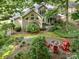 Beautiful backyard featuring a stone fire pit and lush landscaping, creating a tranquil outdoor oasis at 8700 Thornbury Ln, Huntersville, NC 28078
