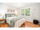 Comfortable bedroom with hardwood floors and natural light, offering a cozy space to rest and recharge at 8700 Thornbury Ln, Huntersville, NC 28078