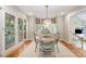 Bright breakfast nook with a bay window, pendant lighting, and access to the outdoor patio at 8700 Thornbury Ln, Huntersville, NC 28078