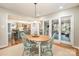 Charming breakfast nook with window seating, stylish light fixture, and sliding door access at 8700 Thornbury Ln, Huntersville, NC 28078