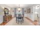 Formal dining room featuring hardwood floors, elegant lighting, and tasteful décor at 8700 Thornbury Ln, Huntersville, NC 28078