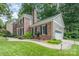 Charming brick home with manicured landscaping, attached garage, and inviting walkway at 8700 Thornbury Ln, Huntersville, NC 28078