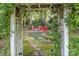 Charming backyard fire pit area with stone pathway and lush landscaping, ideal for outdoor gatherings at 8700 Thornbury Ln, Huntersville, NC 28078