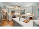 Bright kitchen with white cabinets, stainless steel appliances, tile backsplash, and a ceiling fan at 8700 Thornbury Ln, Huntersville, NC 28078