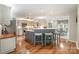 Well-lit kitchen featuring an eat-in island, stainless steel appliances, and seamless integration with the dining area at 8700 Thornbury Ln, Huntersville, NC 28078
