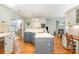 Spacious kitchen with a gray island and hardwood floors, looking towards the living area at 8700 Thornbury Ln, Huntersville, NC 28078