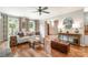 Bright living room with fireplace, hardwood floors, and doorway to foyer at 8700 Thornbury Ln, Huntersville, NC 28078