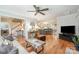 Open-concept living room with hardwood floors that connect to the stairs and kitchen area at 8700 Thornbury Ln, Huntersville, NC 28078