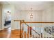 Open staircase features wood steps and white railings with natural light, providing access to multiple levels of the home at 8700 Thornbury Ln, Huntersville, NC 28078