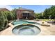 Spacious backyard featuring a private pool, hot tub, outdoor seating area and a lush lawn at 9021 Unbridle Ln, Waxhaw, NC 28173