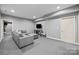 Comfortable basement with plush sectional seating and entertainment area, perfect for relaxation at 9021 Unbridle Ln, Waxhaw, NC 28173