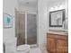 Bright bathroom features a tile shower with glass door and granite countertop vanity at 9021 Unbridle Ln, Waxhaw, NC 28173