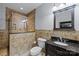 Elegant bathroom featuring a tile shower, vanity with granite countertop, and stylish fixtures at 9021 Unbridle Ln, Waxhaw, NC 28173