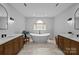 A luxurious primary bathroom features double vanities, a soaking tub, and marble flooring at 9021 Unbridle Ln, Waxhaw, NC 28173