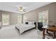 Cozy bedroom with a ceiling fan, soft carpeting, and large windows with blinds at 9021 Unbridle Ln, Waxhaw, NC 28173