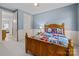 Bedroom showcases a full-size bed, blue accent wall and adjoining bathroom at 9021 Unbridle Ln, Waxhaw, NC 28173