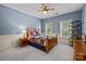A traditional bedroom is styled with a custom quilt, a ceiling fan, and wainscotting at 9021 Unbridle Ln, Waxhaw, NC 28173