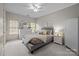 A modern bedroom is decorated with neutral paint, carpet, and plenty of natural light at 9021 Unbridle Ln, Waxhaw, NC 28173