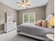 This bedroom is decorated with neutral paint, plush carpet, and plenty of natural light at 9021 Unbridle Ln, Waxhaw, NC 28173