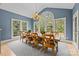 Bright dining room with large windows, blue walls and traditional decor at 9021 Unbridle Ln, Waxhaw, NC 28173