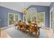 Bright dining room with large windows, chandelier, and views of the surrounding greenery at 9021 Unbridle Ln, Waxhaw, NC 28173