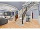 A view of the foyer featuring hardwood floors and wrought iron staircase, transitioning into the open living area at 9021 Unbridle Ln, Waxhaw, NC 28173