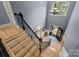 Upstairs view showcasing hardwood floors, and staircase leading to the front door, highlighting natural light at 9021 Unbridle Ln, Waxhaw, NC 28173