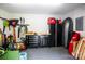 Well-organized garage space with black tool chests, storage cabinets, and various yard maintenance tools at 9021 Unbridle Ln, Waxhaw, NC 28173