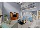 Open-concept living room with a balcony, two-story ceilings and large entertainment center at 9021 Unbridle Ln, Waxhaw, NC 28173