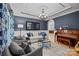 Comfortable living room featuring a piano, blue accents, and decorative lighting fixture at 9021 Unbridle Ln, Waxhaw, NC 28173