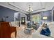 Living room featuring hardwood floors, blue accents, and view of the staircase and foyer at 9021 Unbridle Ln, Waxhaw, NC 28173