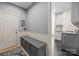 Inviting mudroom with bench seating, coat hooks, and convenient access to the laundry area at 9021 Unbridle Ln, Waxhaw, NC 28173