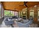 Relaxing screened porch with a stone fireplace, ceiling fans, and wicker furniture at 9021 Unbridle Ln, Waxhaw, NC 28173